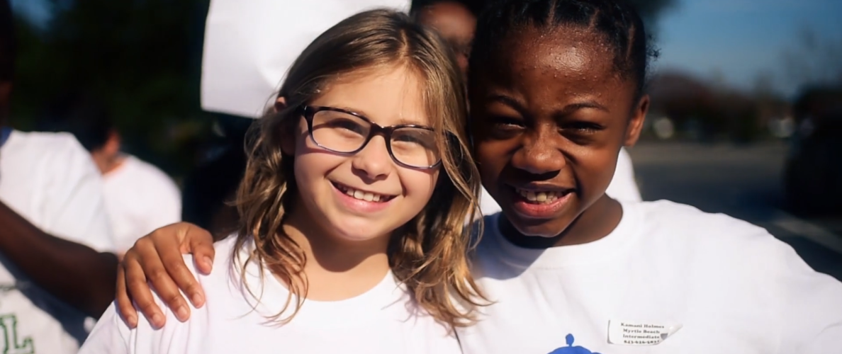 Kids wearing Touchstone Energy logo on t-shirts